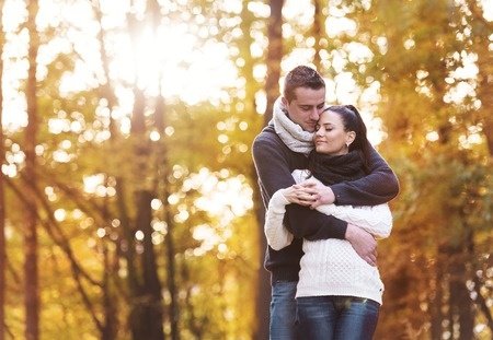 beautiful couple in love on a walk in autumn forest