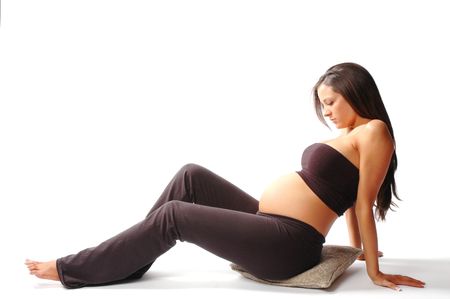 a pregnant woman is sitting thinking about her